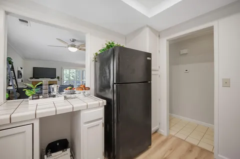 a bedroom with a bed and a lamp on dresser