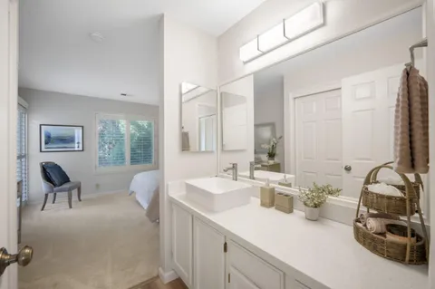 a bathroom with a sink and mirror with toilet