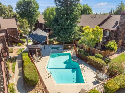 a front view of a house with a yard and fountain