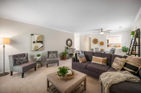 a living room with furniture a flat screen tv and a fireplace