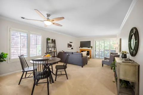 a view of a dining room with furniture and a chandelier