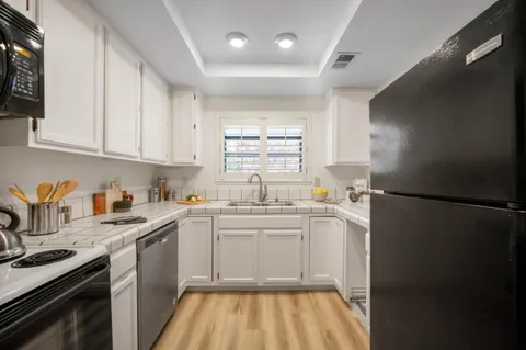 a kitchen with a sink stove and microwave