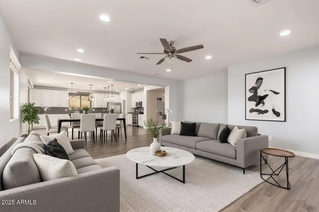 a living room with furniture and view of kitchen