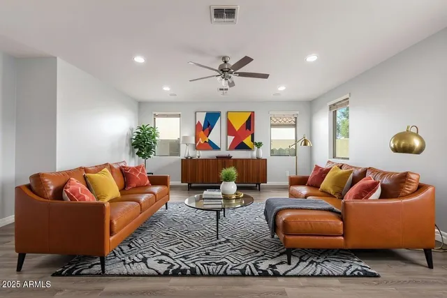 a living room with furniture a rug and a chandelier