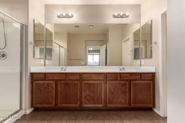 a bathroom with a double vanity sink and a mirror