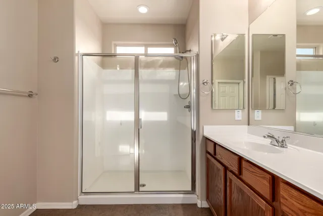 a bathroom with a shower sink and mirror