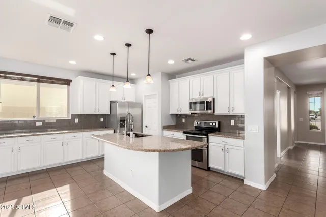 a kitchen with stainless steel appliances granite countertop a sink and stove