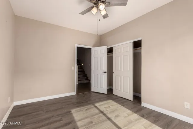 a view of an empty room with a ceiling fan
