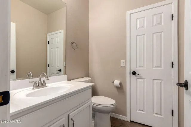 a bathroom with a sink a toilet and a mirror