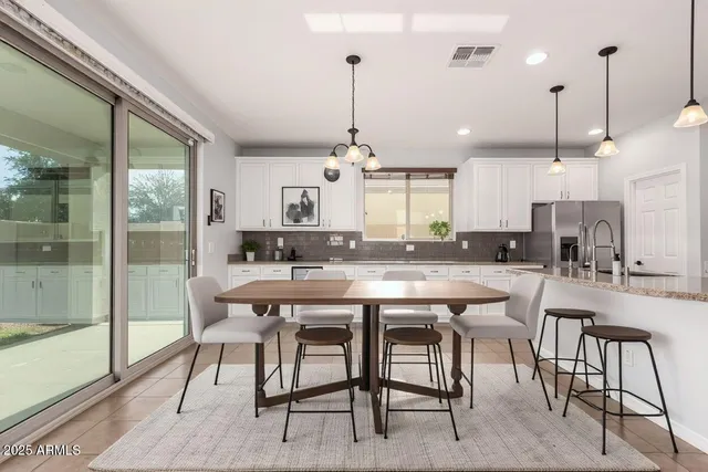 a large kitchen with a table and chairs