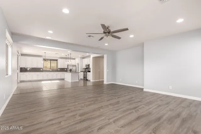 a view of empty room with wooden floor