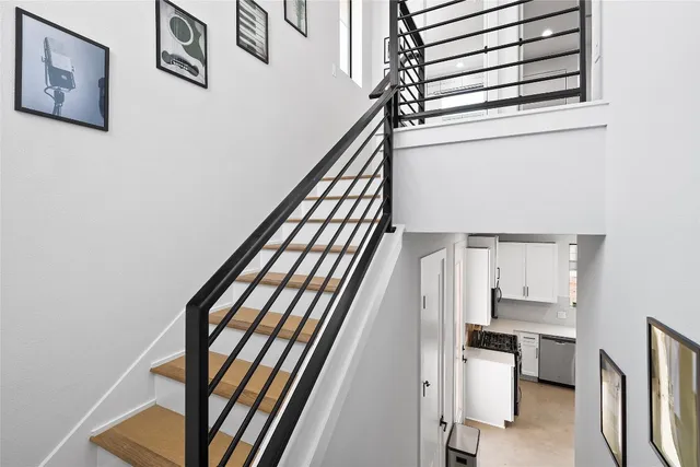 a view of stairs and an entryway with wooden floor