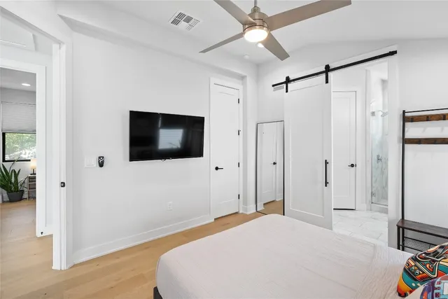 a bedroom with a bed and a flat screen tv