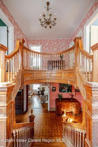 a living room with furniture fireplace and a large window