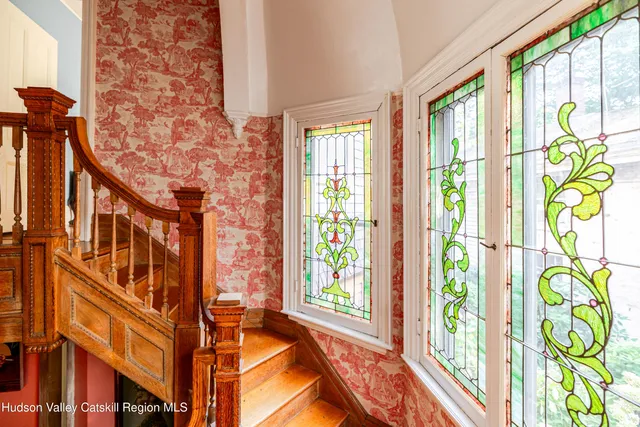 a bedroom with furniture and wooden floor