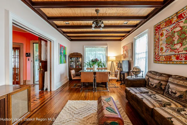 a kitchen with stainless steel appliances a stove a refrigerator and a sink with wooden floor