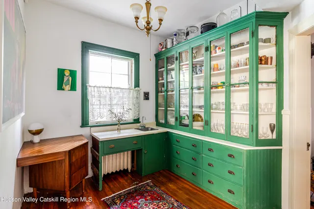 a hallway with wooden floor and windows