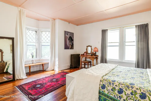 a bedroom with a large bed and a window