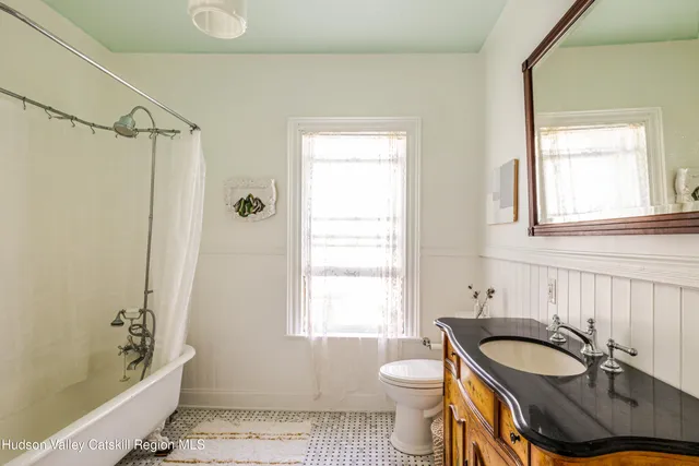 a view of a workspace with furniture and wooden floor