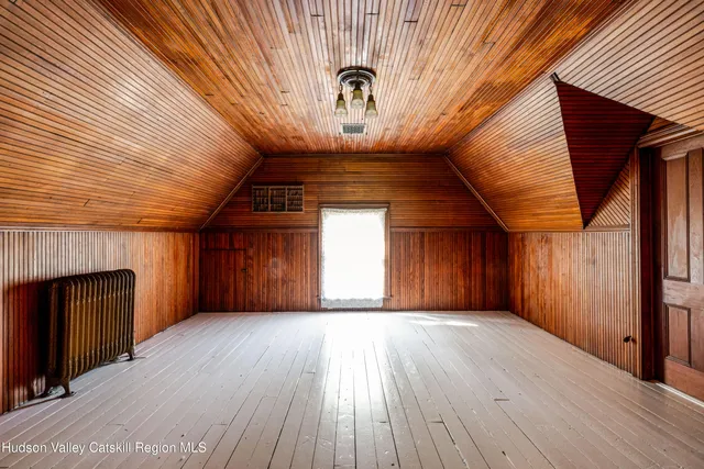 a white house that has a tree in front of the house