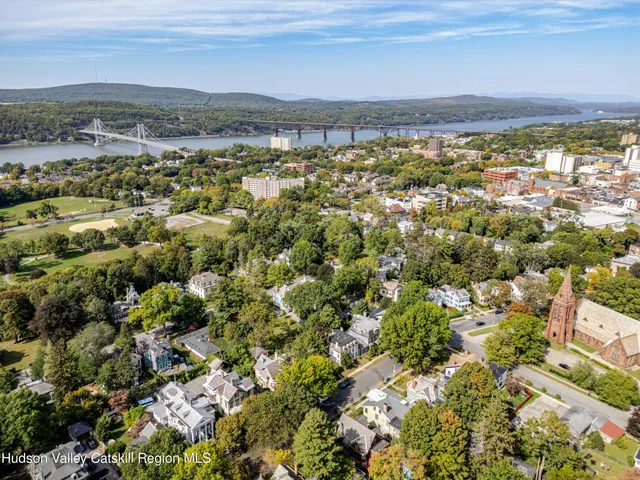a view of a porch with wooden floor and furniture