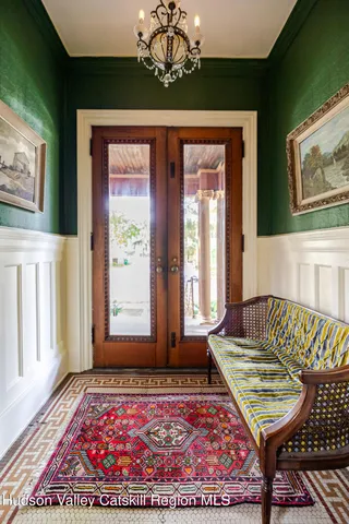 a view of entryway and hall with wooden floor