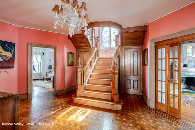 a living room with furniture a fireplace and large windows