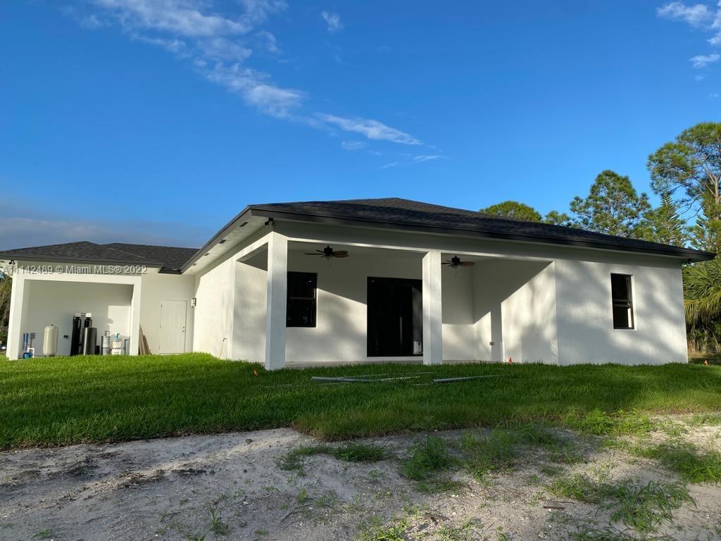 17566 93rd Road North Loxahatchee, FL 33470 - Photo 6 of 6 a front view of a house with a yard and garage