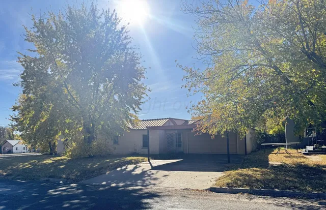 a wooden bench sitting in middle of a yard