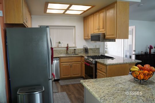 420 Christopher Court Ridgecrest, CA 93555 - Photo 8 of 32 a kitchen with stainless steel appliances granite countertop a sink stove and refrigerator