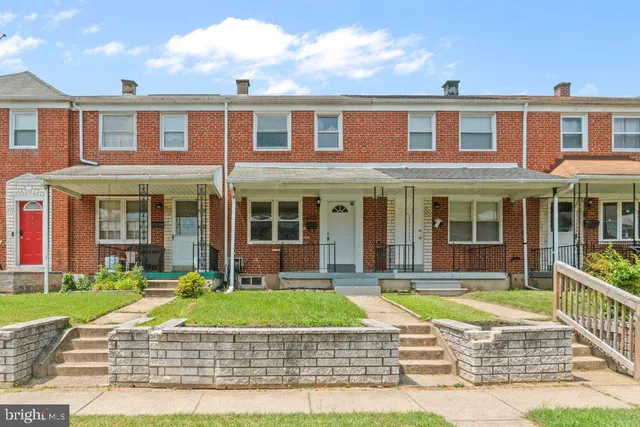 a front view of a house with a yard table and chairs