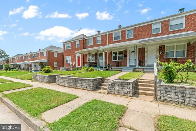 a kitchen with granite countertop a sink and refrigerator
