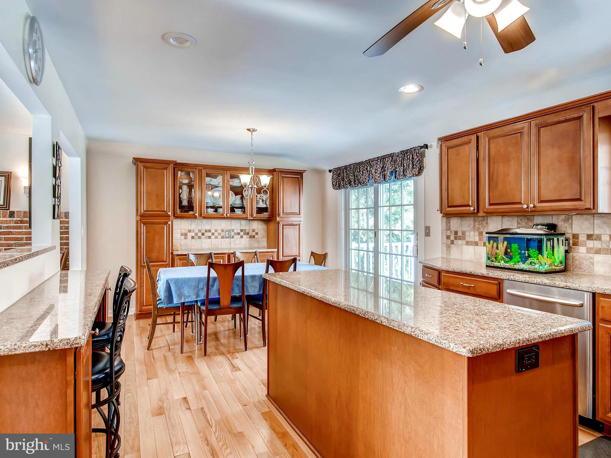 2607 Fallston Road Fallston, MD 21047 - Photo 12 of 30 a view of a kitchen with kitchen island a sink a stove and wooden floors