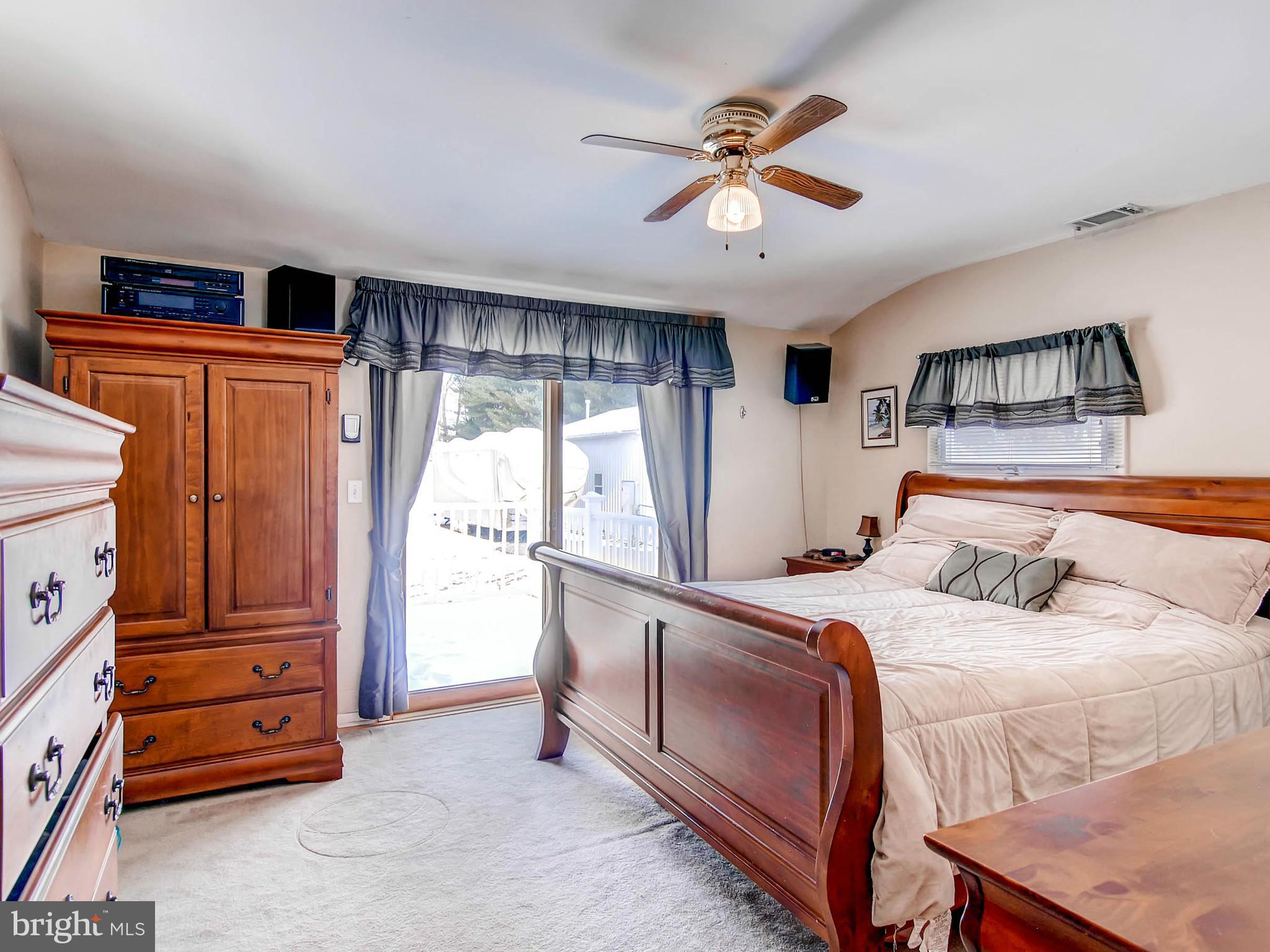 2607 Fallston Road Fallston, MD 21047 - Photo 14 of 30 a bedroom with a bed and a chandelier