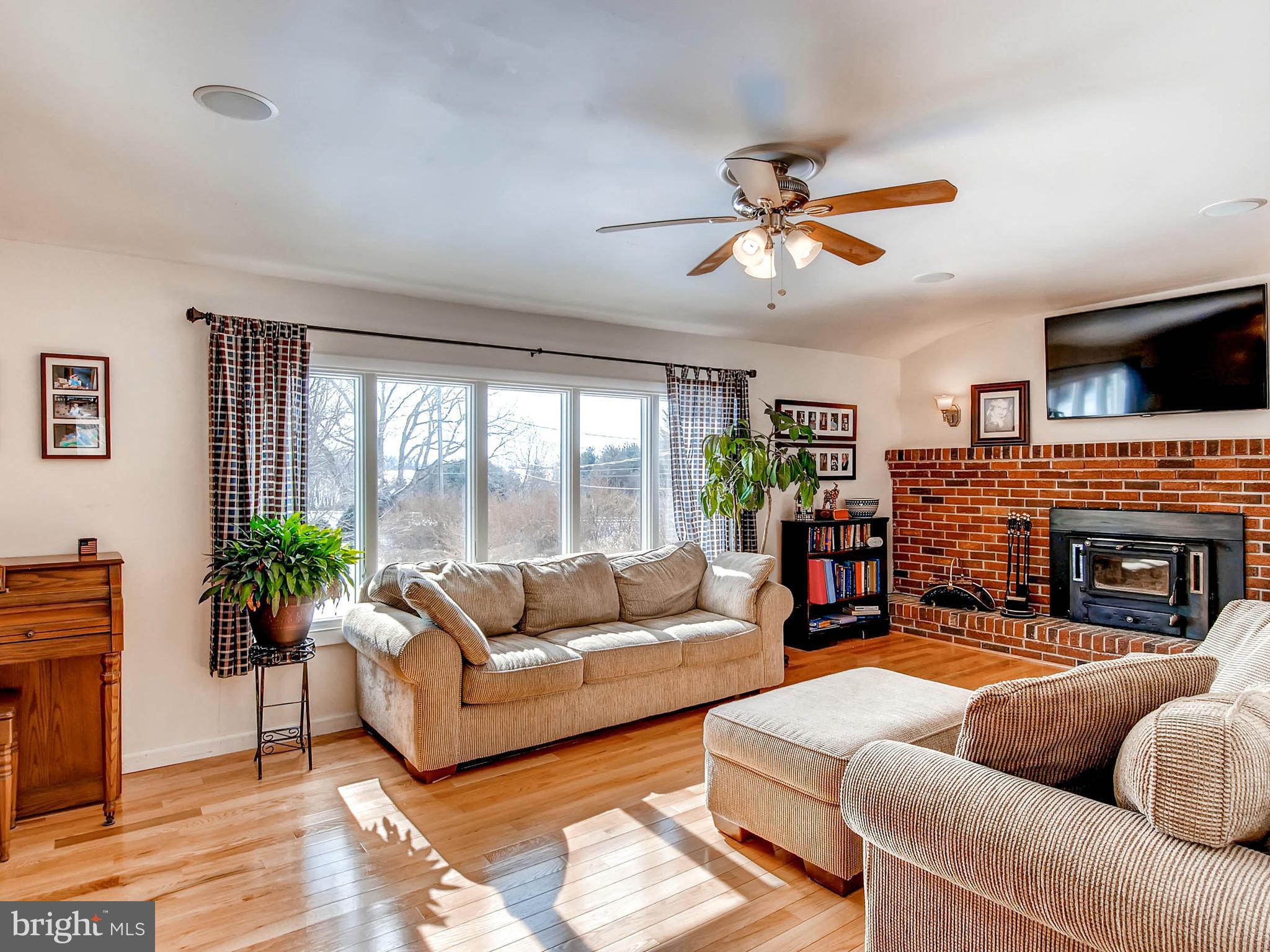 2607 Fallston Road Fallston, MD 21047 - Photo 6 of 30 a living room with furniture a fireplace and a large window