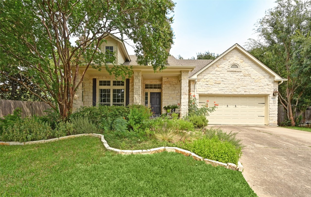 a view of a house with a yard and plants