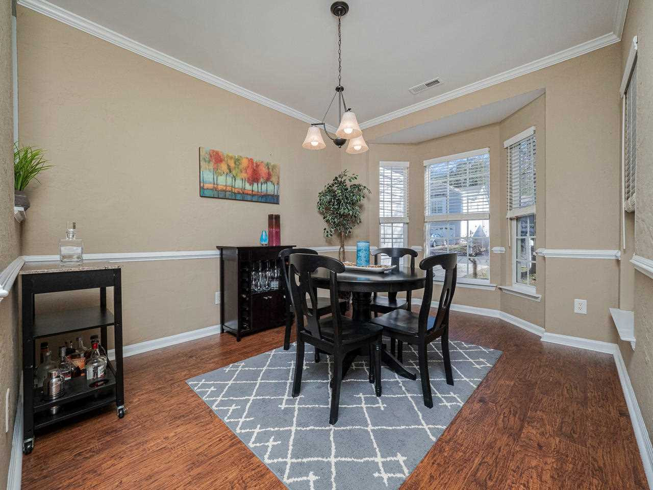 8429 Whisper Ridge Place Raleigh, NC 27613 - Photo 4 of 27 Large Dining room with Bump out Bay window and pass through into Kitchen Dining Room