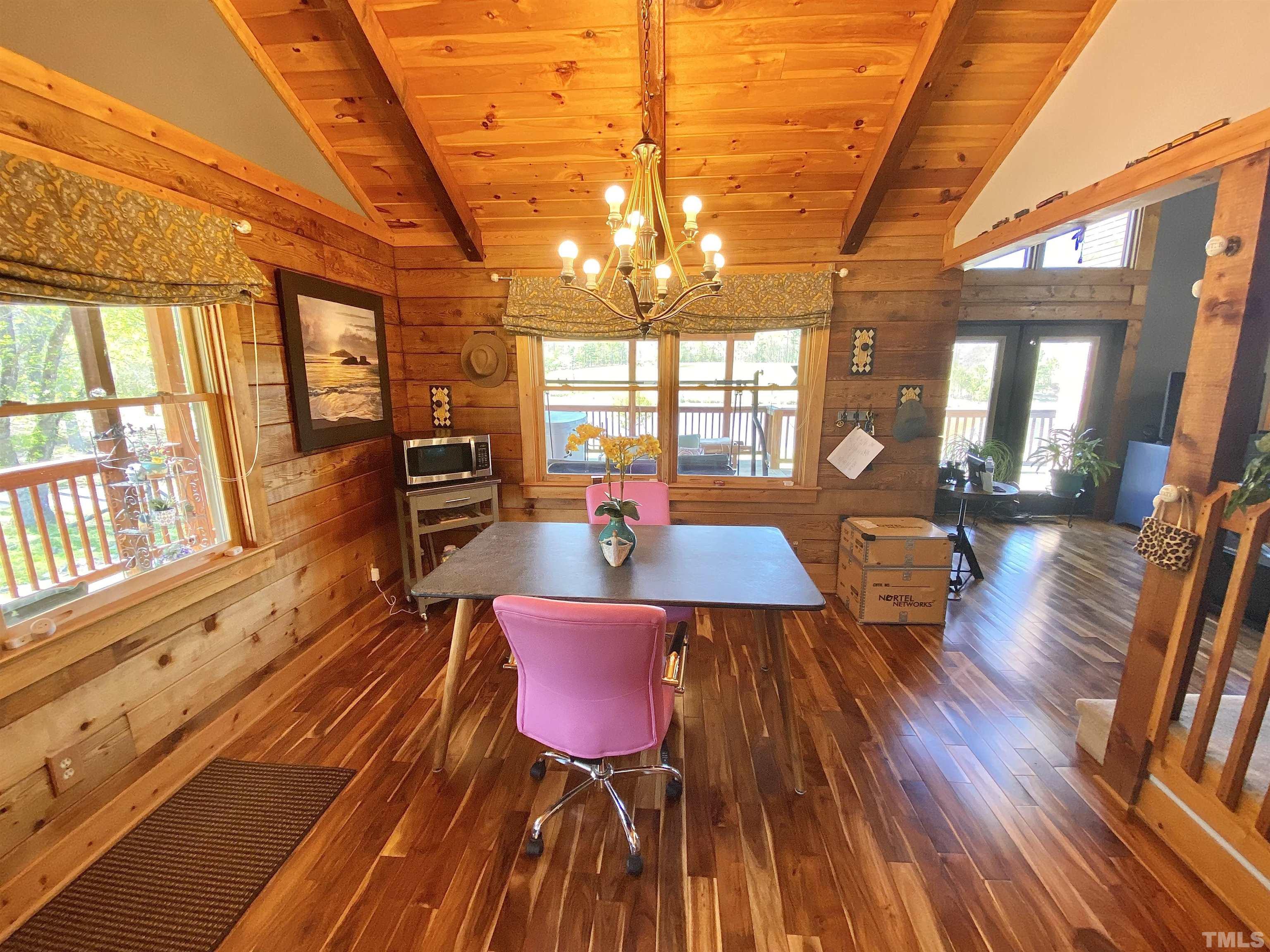 533 Enon Road Oxford, NC 27565 - Photo 15 of 95 a view of a dining room with furniture a chandelier and wooden floor