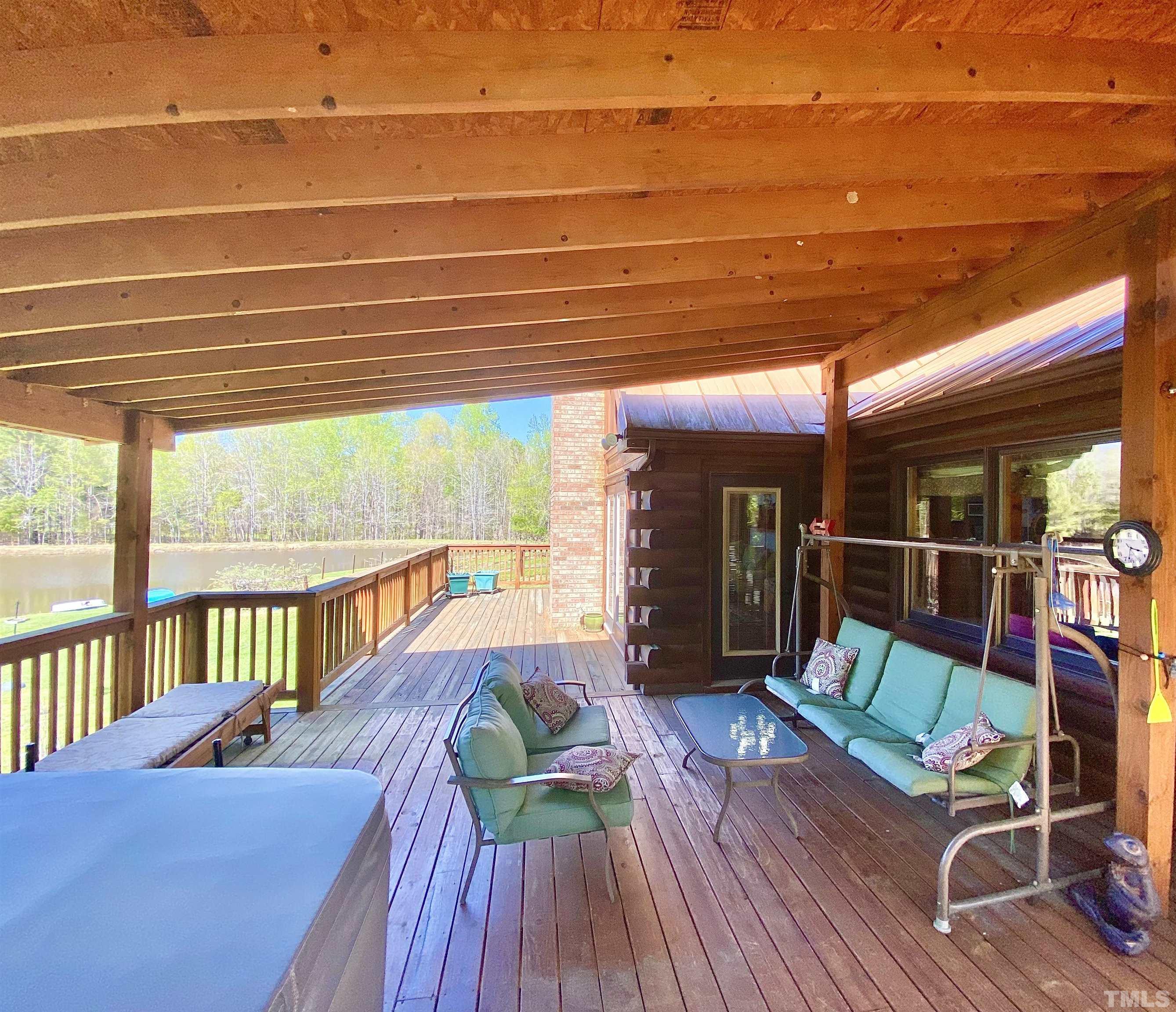533 Enon Road Oxford, NC 27565 - Photo 34 of 95 a view of a patio with table and chairs with wooden floor