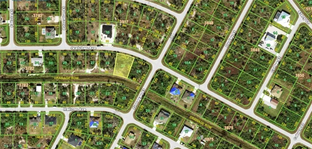 a view of swimming pool with a large tree and a yard in back