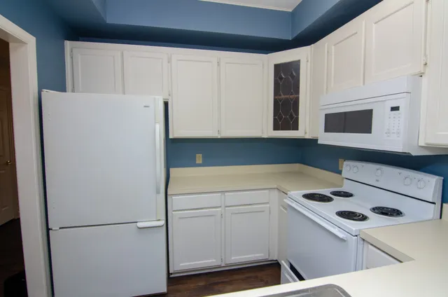 a view of a kitchen with refrigerator and microwave