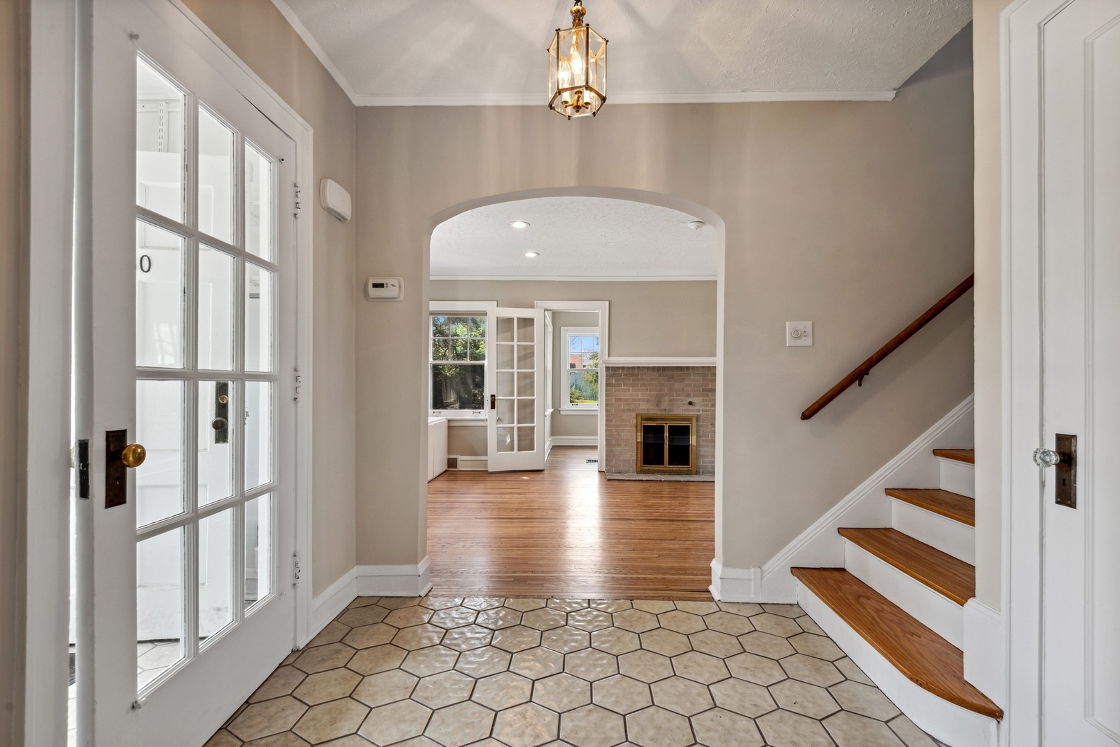 1130 Ridge Road Wilmette, IL 60091 - Photo 3 of 16 a view of staircase with white walls and chandelier