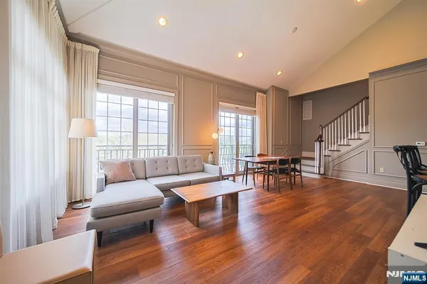 a living room with fireplace furniture and a large window
