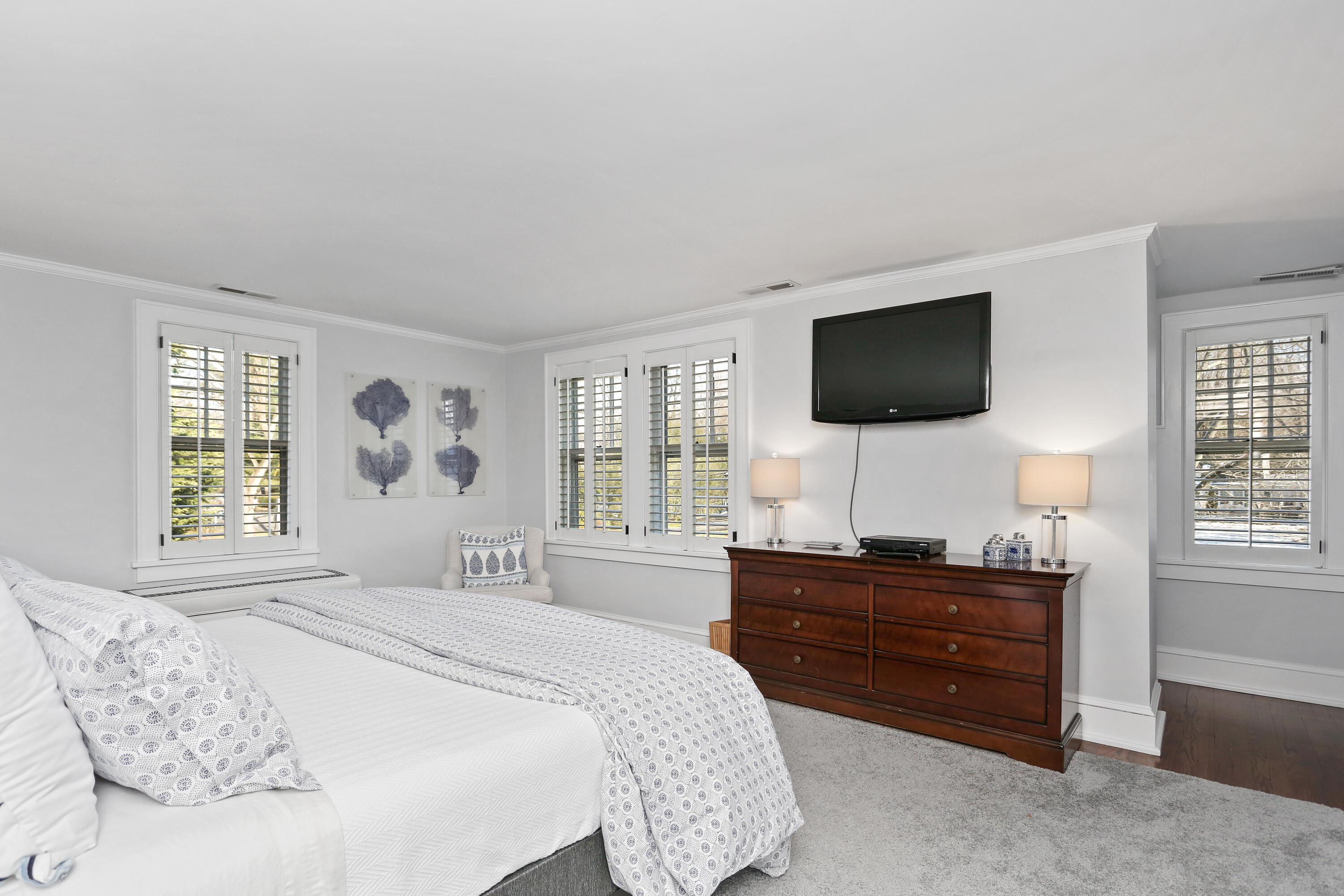 8 Beach Drive Darien, CT 06820 - Photo 15 of 27 a bedroom with a bed and a flat screen tv