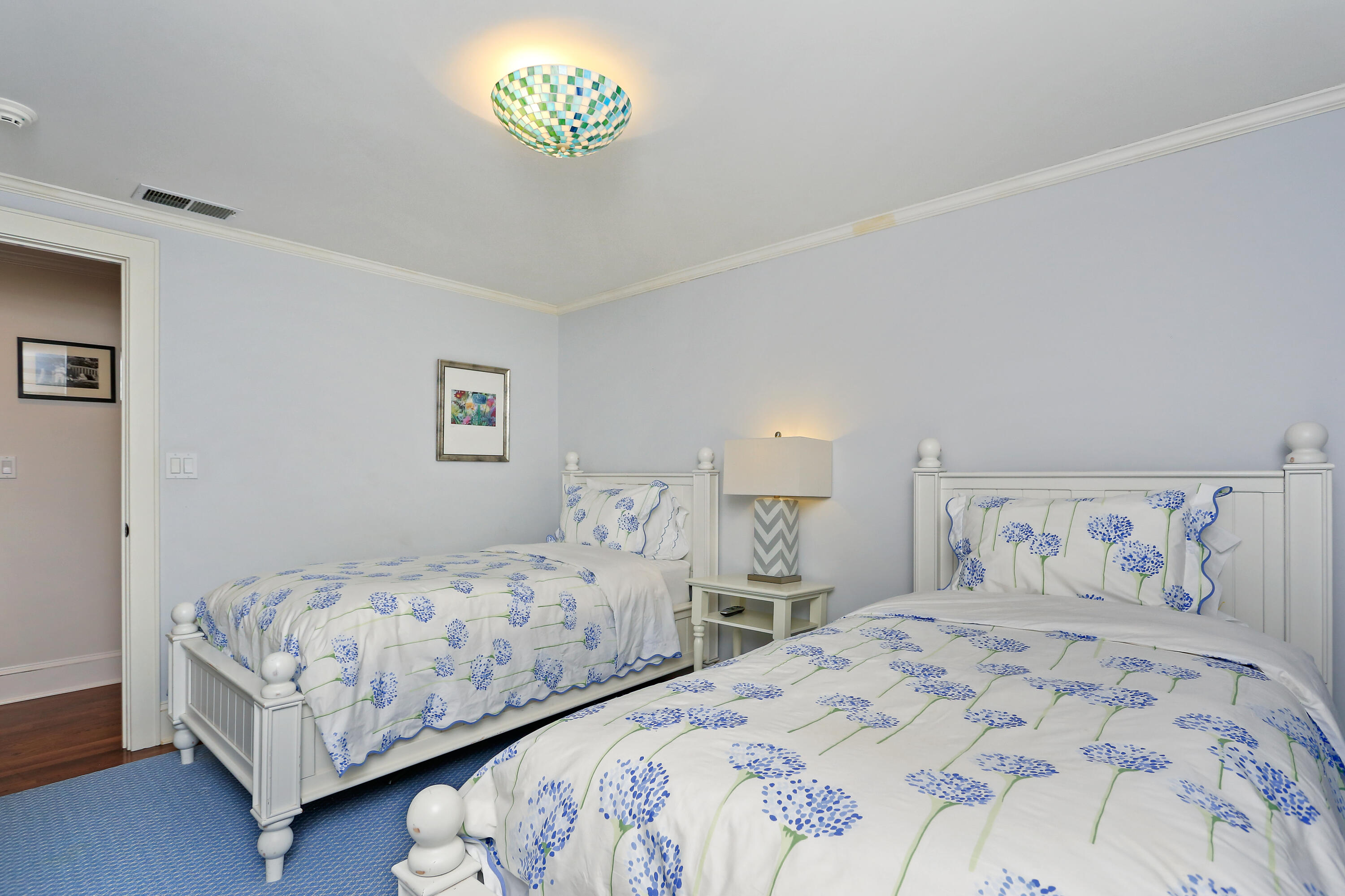 8 Beach Drive Darien, CT 06820 - Photo 19 of 27 a bedroom with a bed and a chandelier