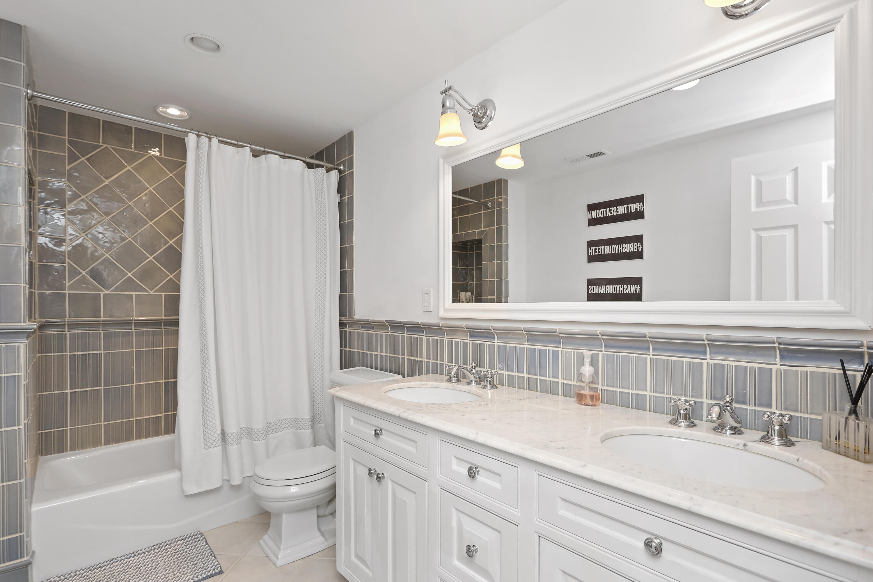 8 Beach Drive Darien, CT 06820 - Photo 21 of 27 a bathroom with a double vanity sink toilet and shower