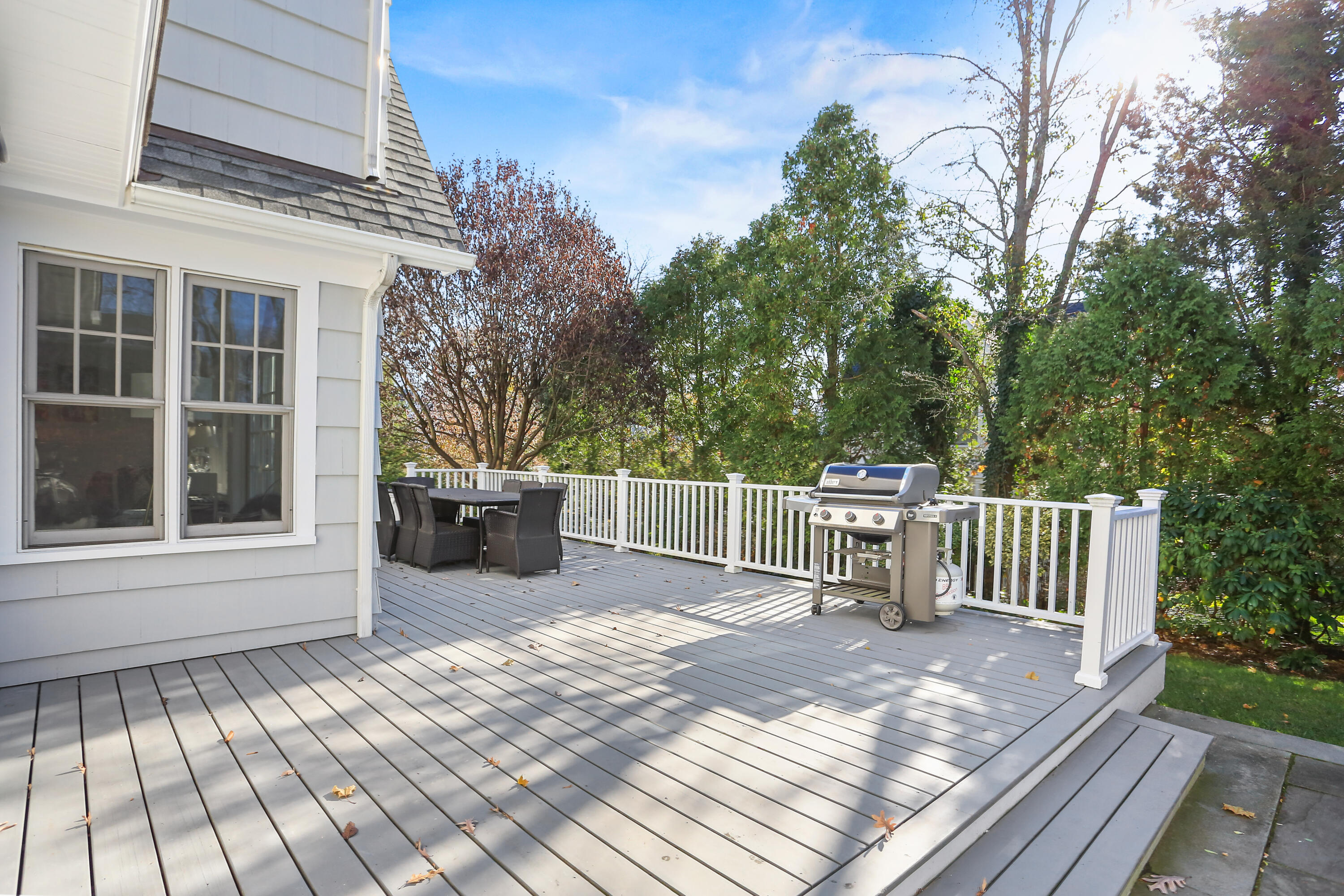 8 Beach Drive Darien, CT 06820 - Photo 4 of 27 a view of a chair and tables the back yard of the house