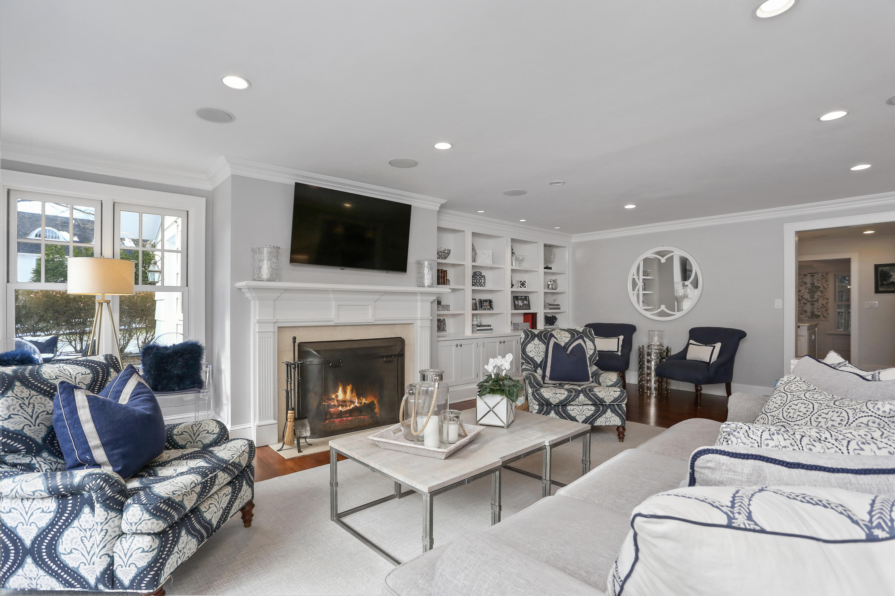8 Beach Drive Darien, CT 06820 - Photo 7 of 27 a living room with furniture a flat screen tv and a fireplace