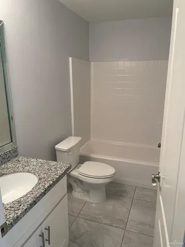 a view of a small space with a chandelier fan and windows