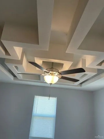 a view of a chandelier fan in a room